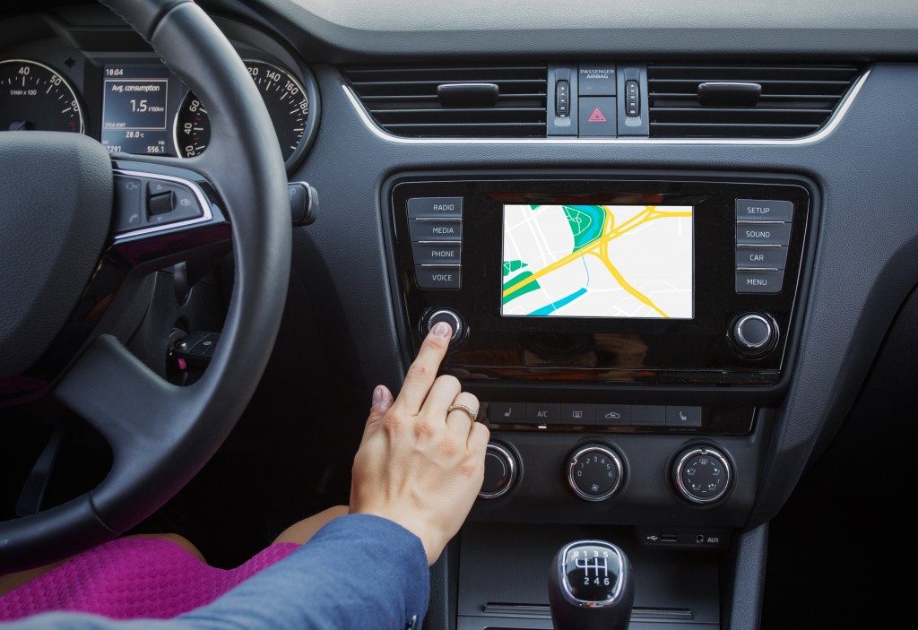 Woman using navigation system while driving a car