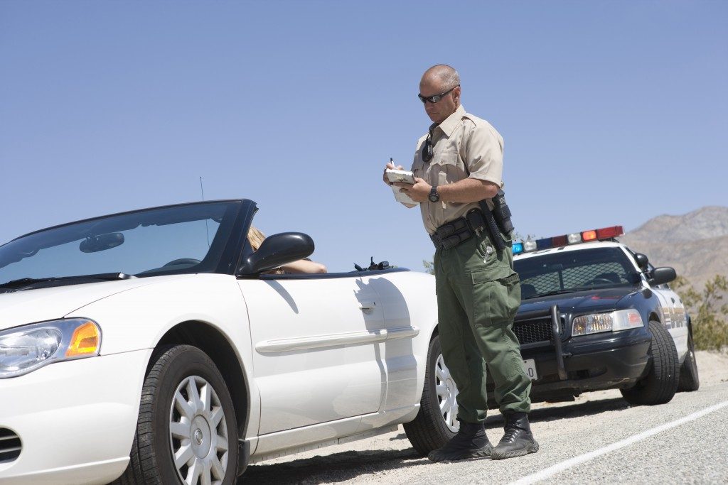 High way patrol with his car stopped a car 