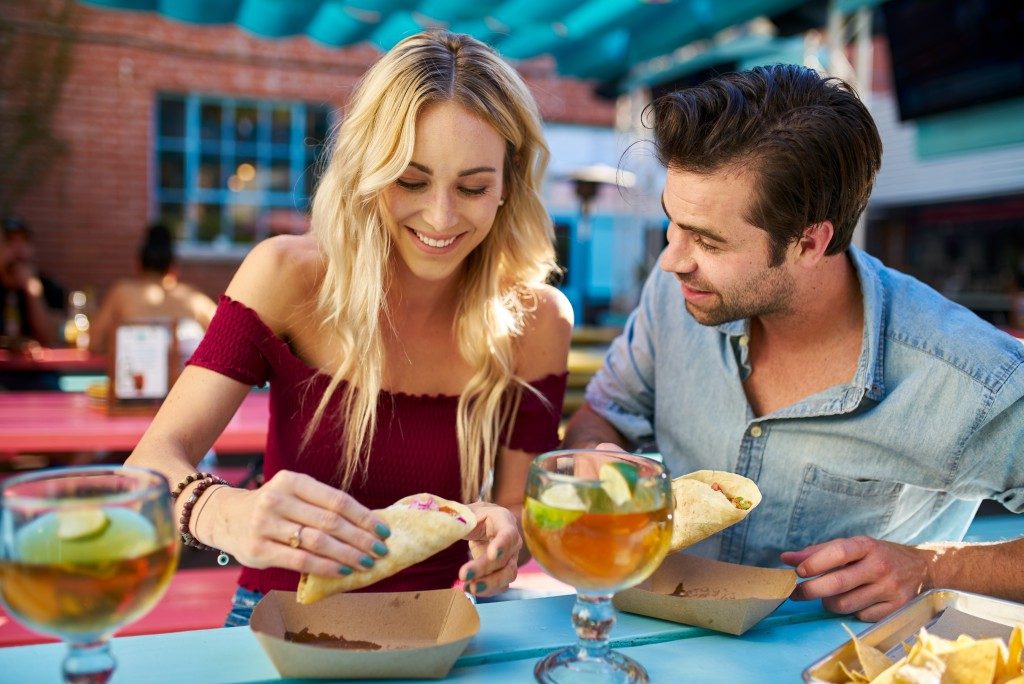 Eating taco with cocktail drinks on a date night