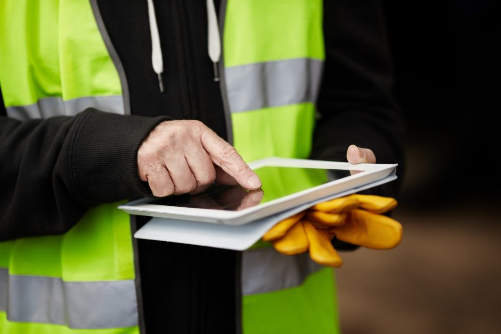 man at a construction site using a tablet