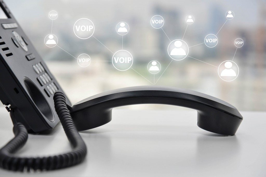 telephone device with illustration icon of voip services and networking data center on background