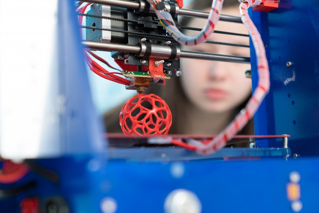 3D printer printing a red ball