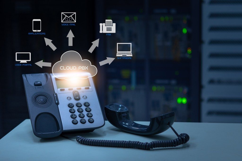 telephone device with illustration icon of voip services and networking data center on background