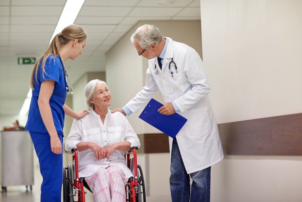 doctor and nurse attending to an elderly patient