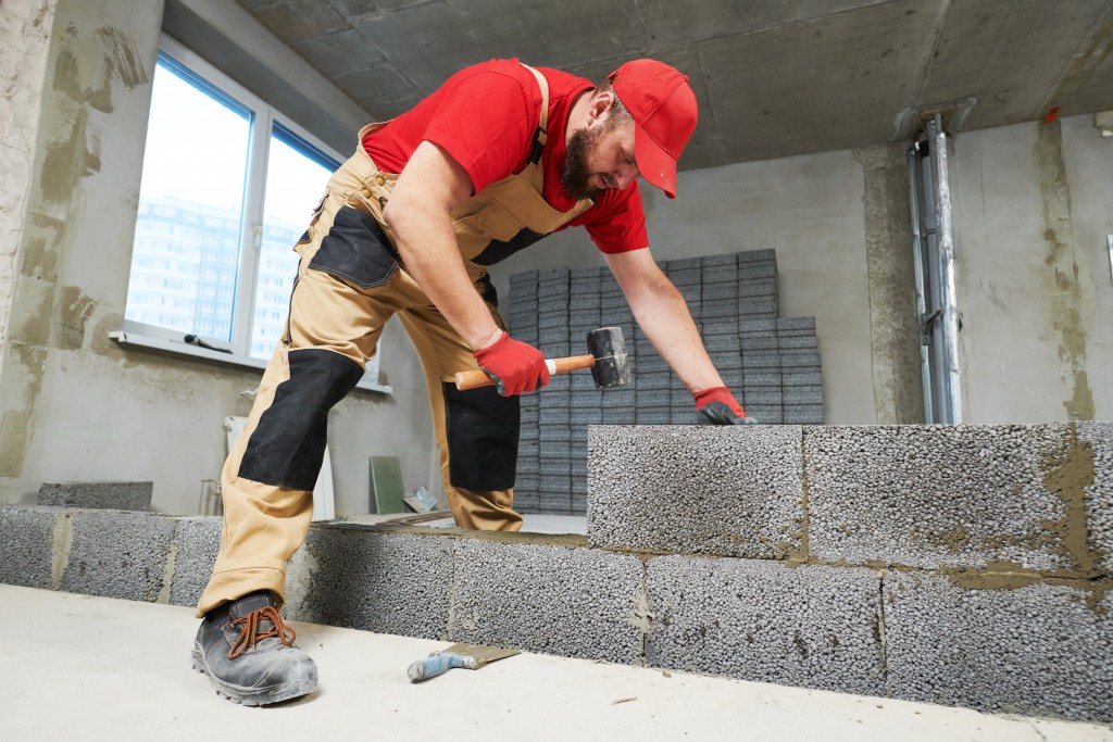 bricklayer working with ceramsite concrete blocks.