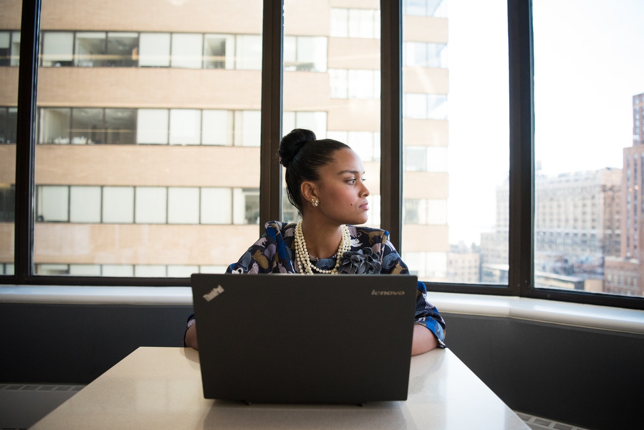 person thinking deeply in front of laptop