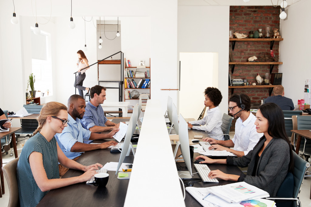 Business colleagues working at a busy open plan office