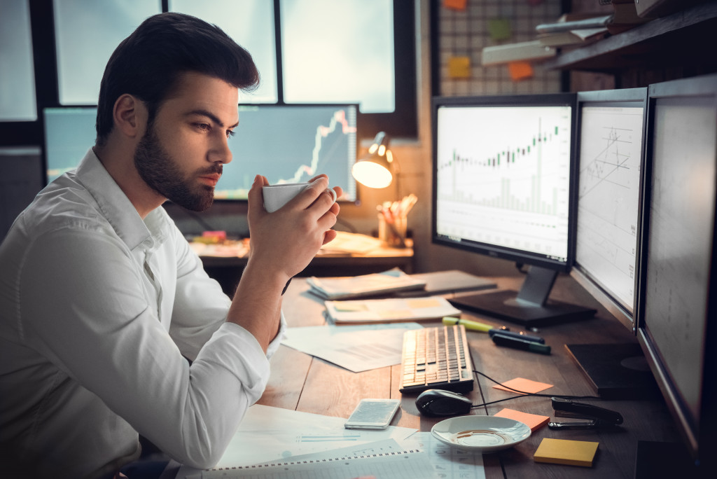 man in front of monitors researching