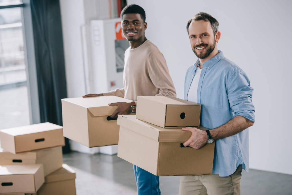 two men carrying boxes