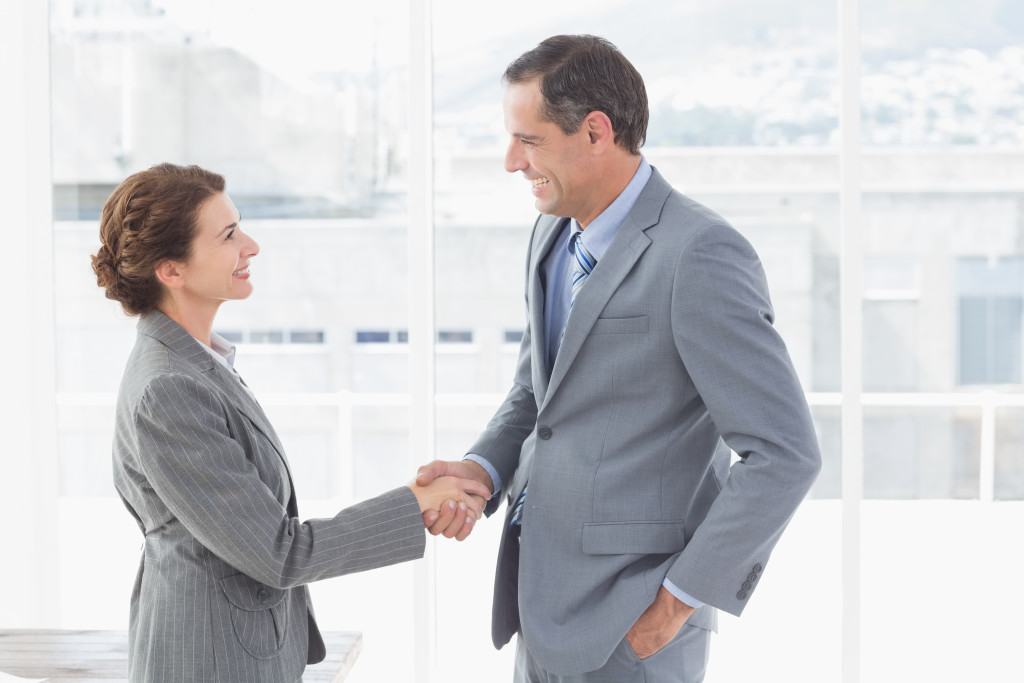 man and woman shaking hands