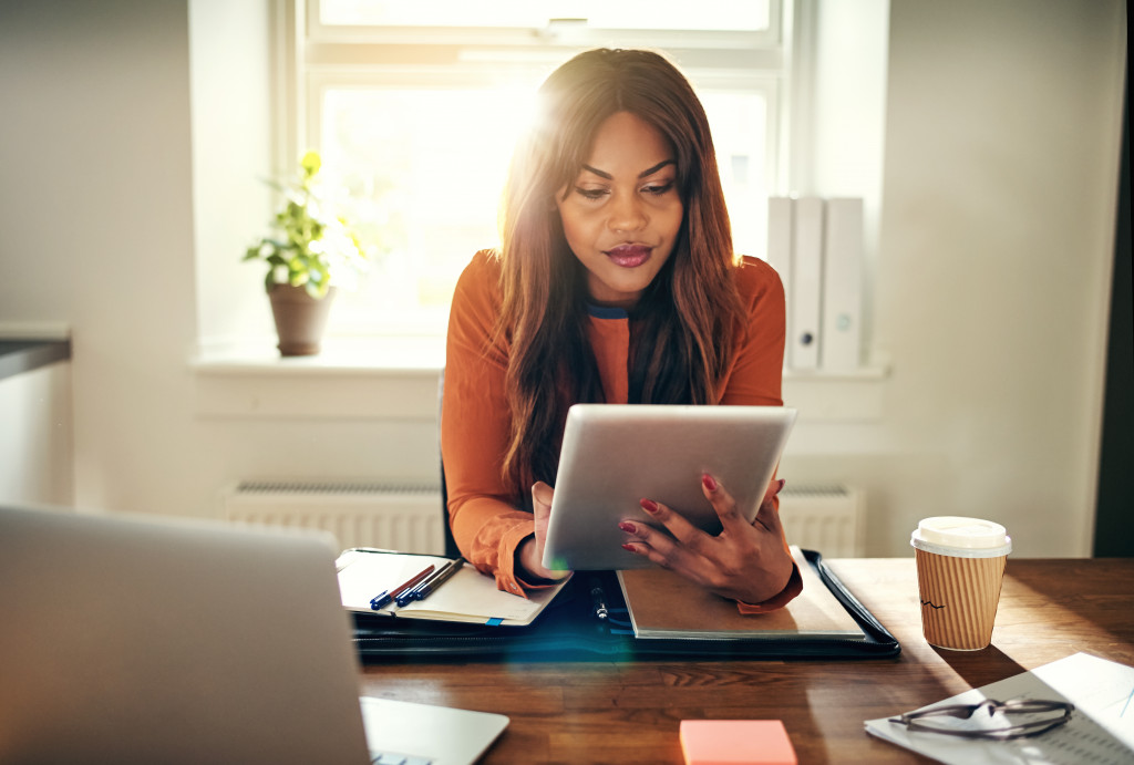 a woman using a computer tablet