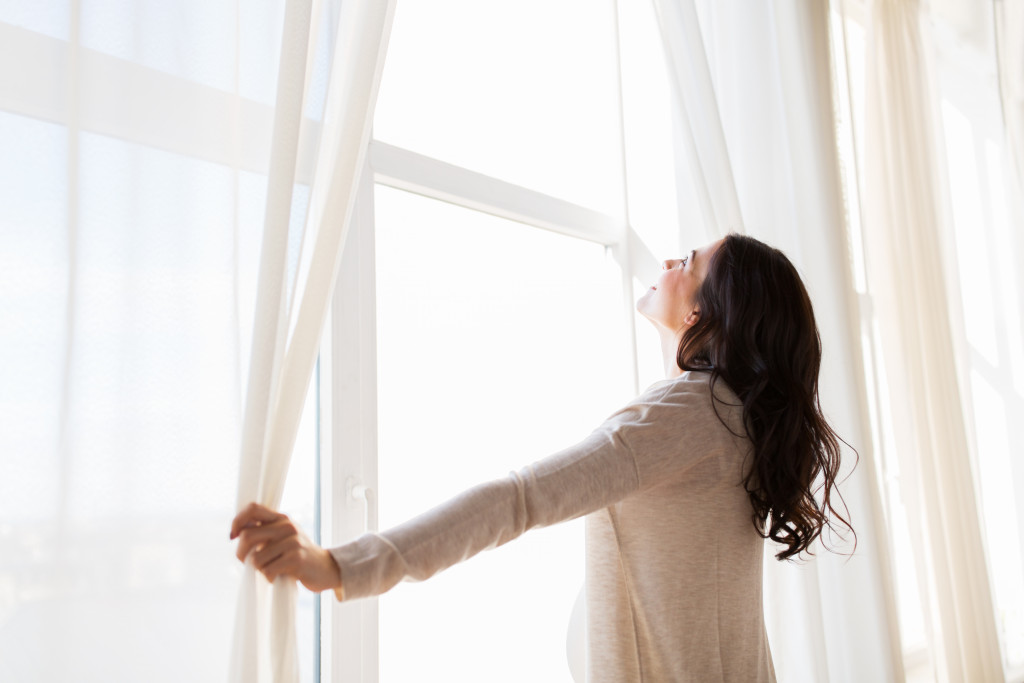 a person holding a curtain