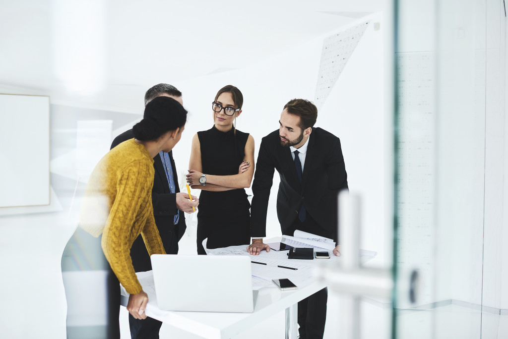 employees discussing business problems together