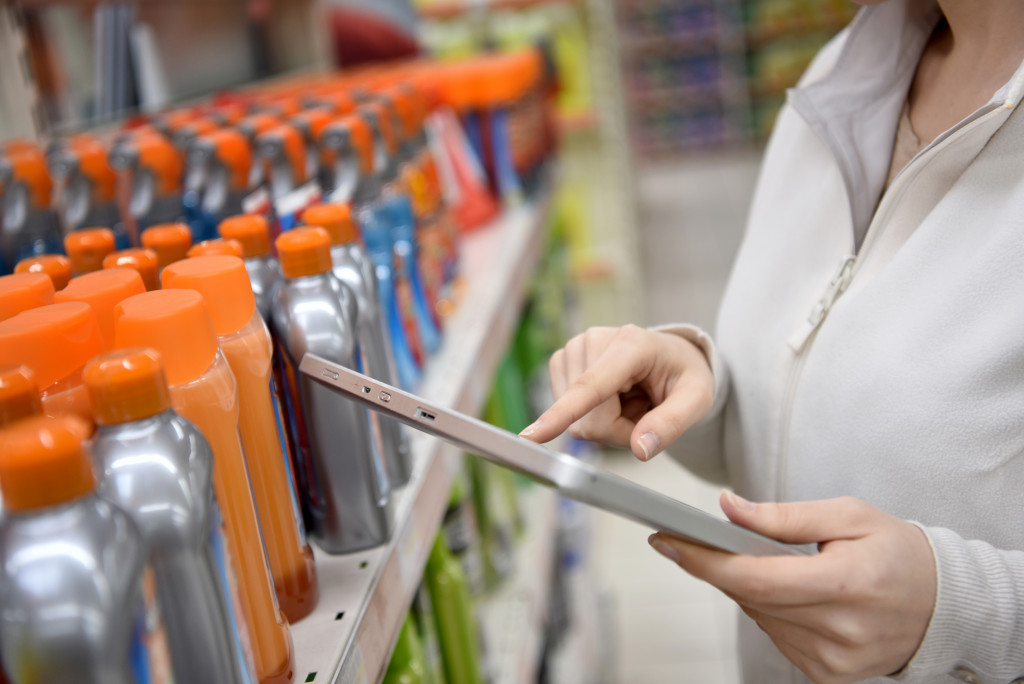 a woman is checking the products in her stock