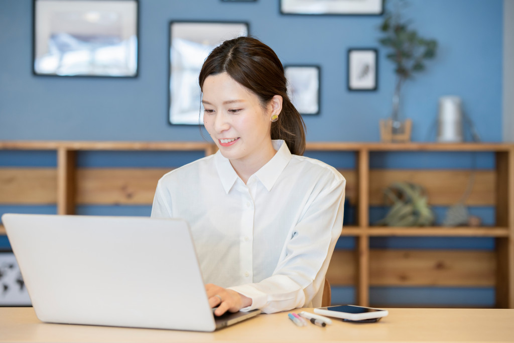 A woman using a laptop in her home office