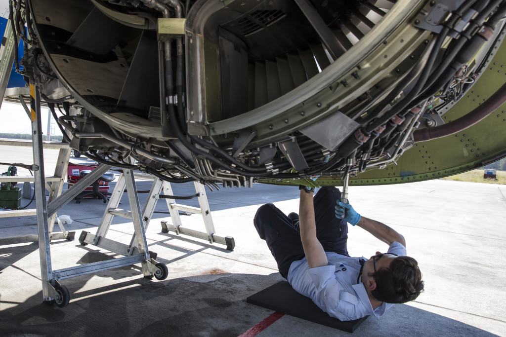 An engineer repairing an aircraft propeller