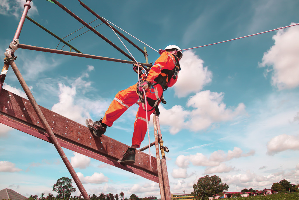 A construction worker wearing complete PPE with harness