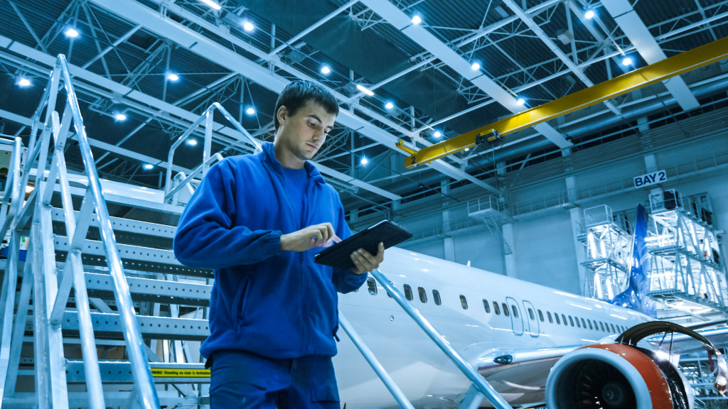 airplane inspector using tablet to check components and stats