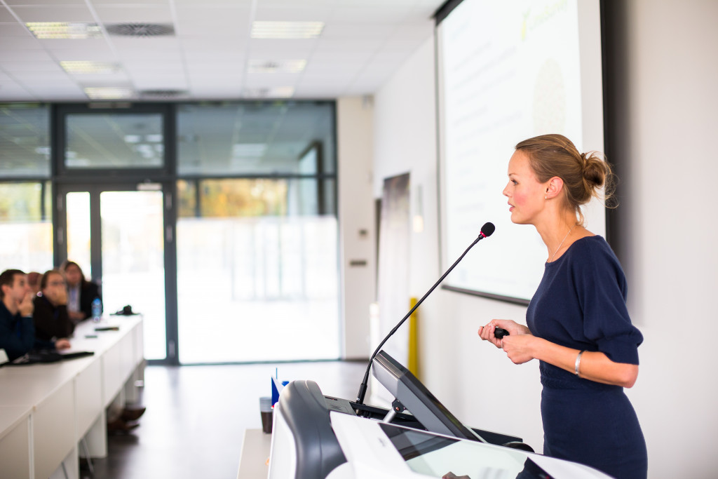 A woman standing in front of conference