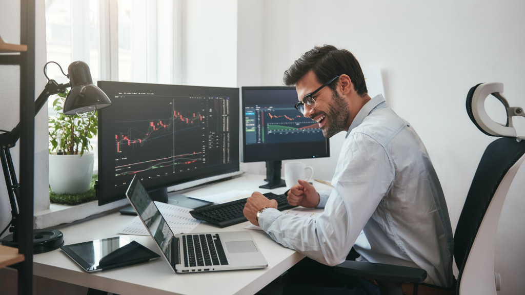 man working with multiple screens