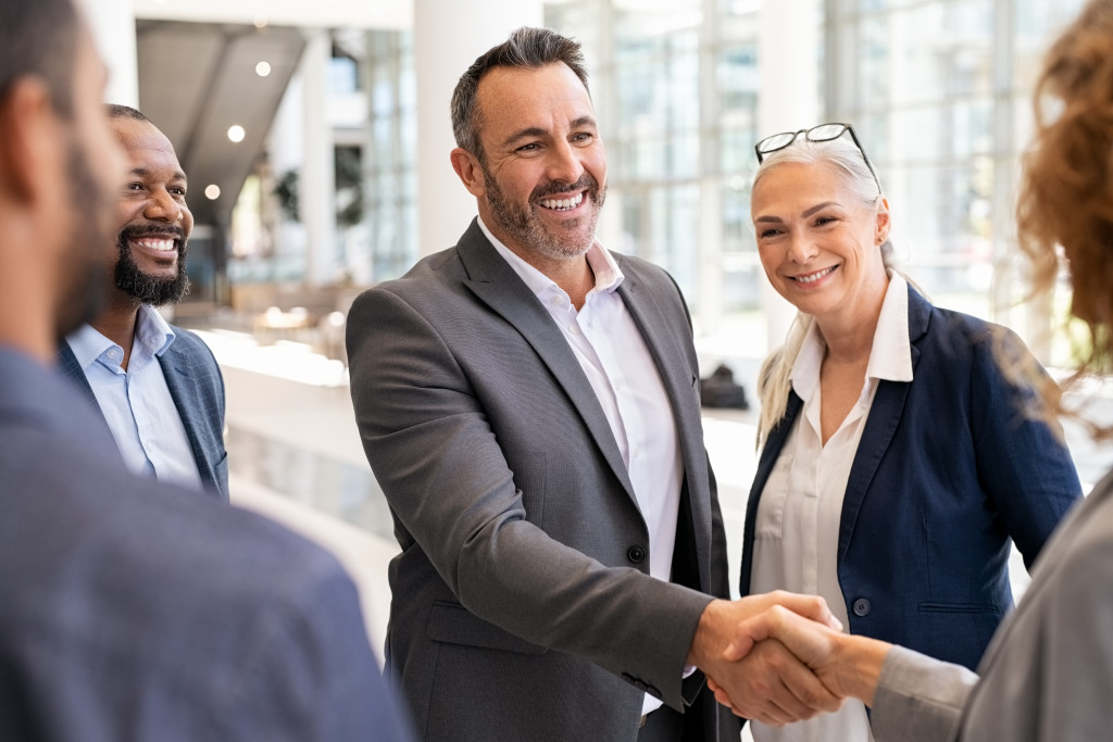 business people shaking hands and smiling