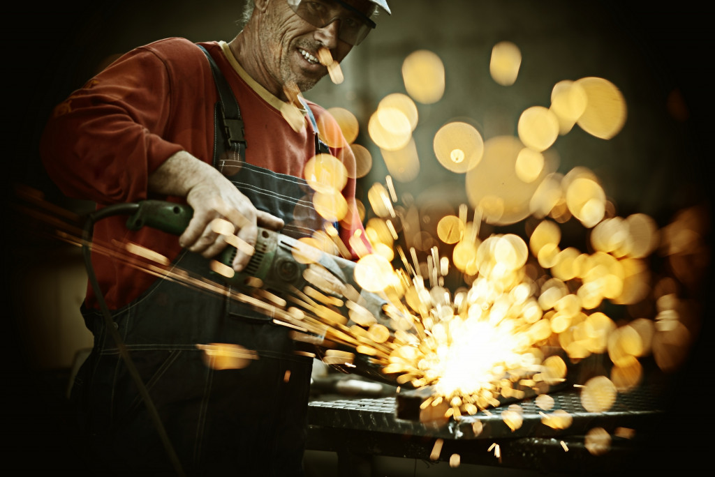 industrial worker cutting metal