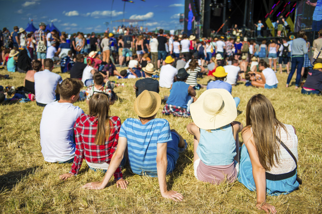 friends at a music fest resting together