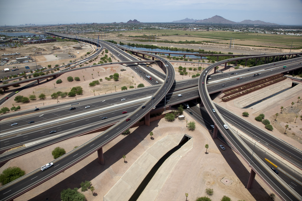 winding expressways in a barren wasteland near a distant city