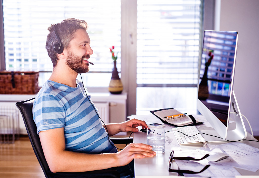 Young man focused on his computer while working at home.