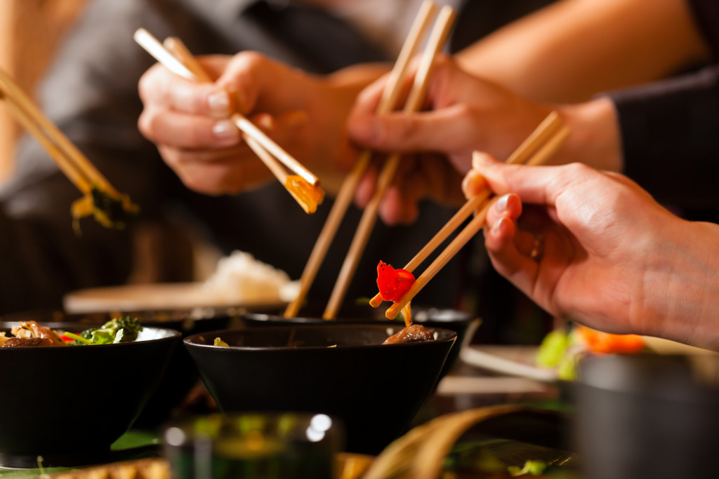 people eating with chopsticks