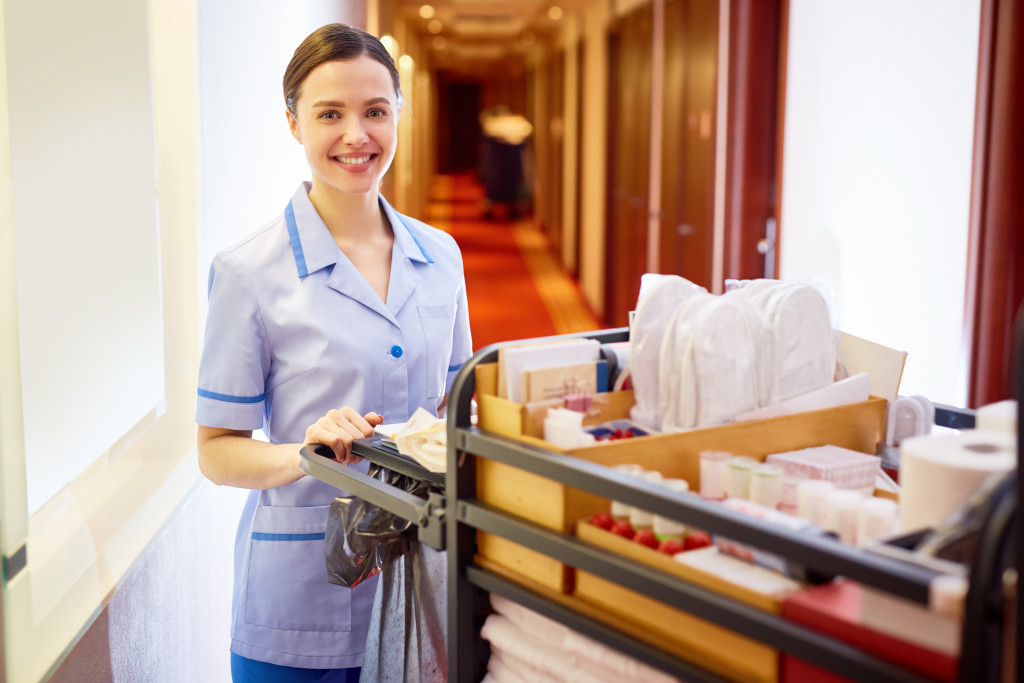 hotel bed and linen being managed by hotel staff